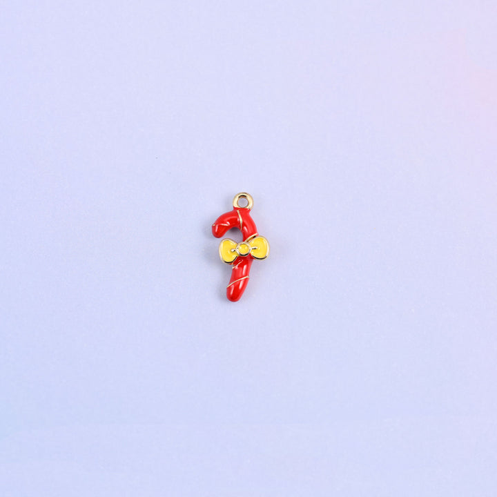 Single red candy cane charm with a gold spiral stripe and a yellow enamel bow at the crook.