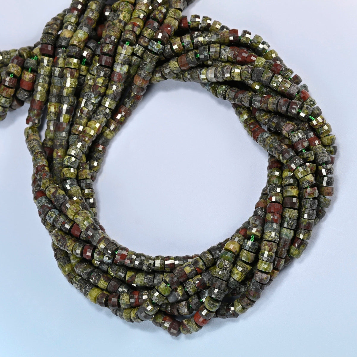 Dragon blood stone faceted heishi disc beads coiled into overlapping loops, whole strands of earthy green and red stone