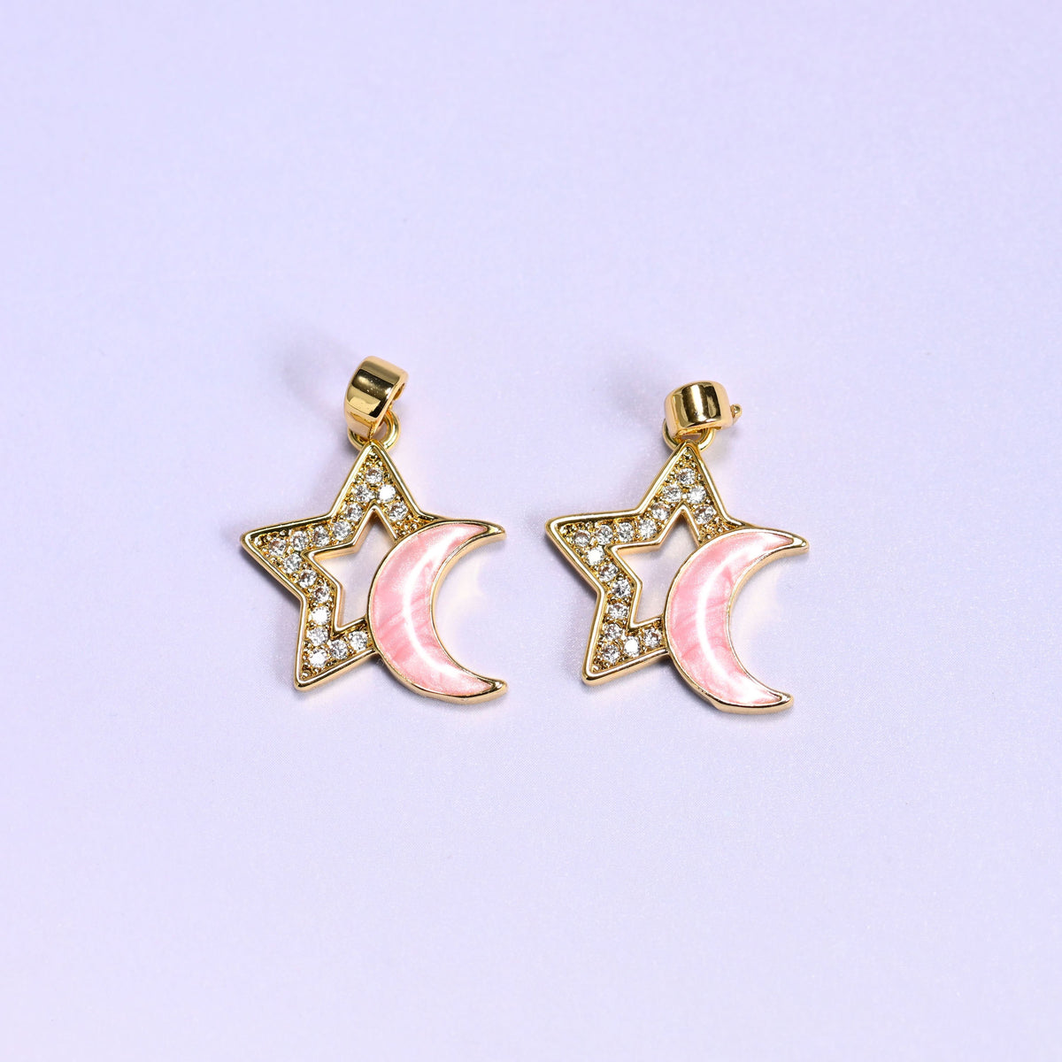 Two pink Star Shell Moon Zirconia Charms side by side, each with a pink shell crescent moon nested inside a zirconia pave star outline.