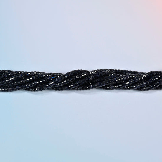 Strands of blue sandstone faceted heishi disc beads twisted together in a horizontal row