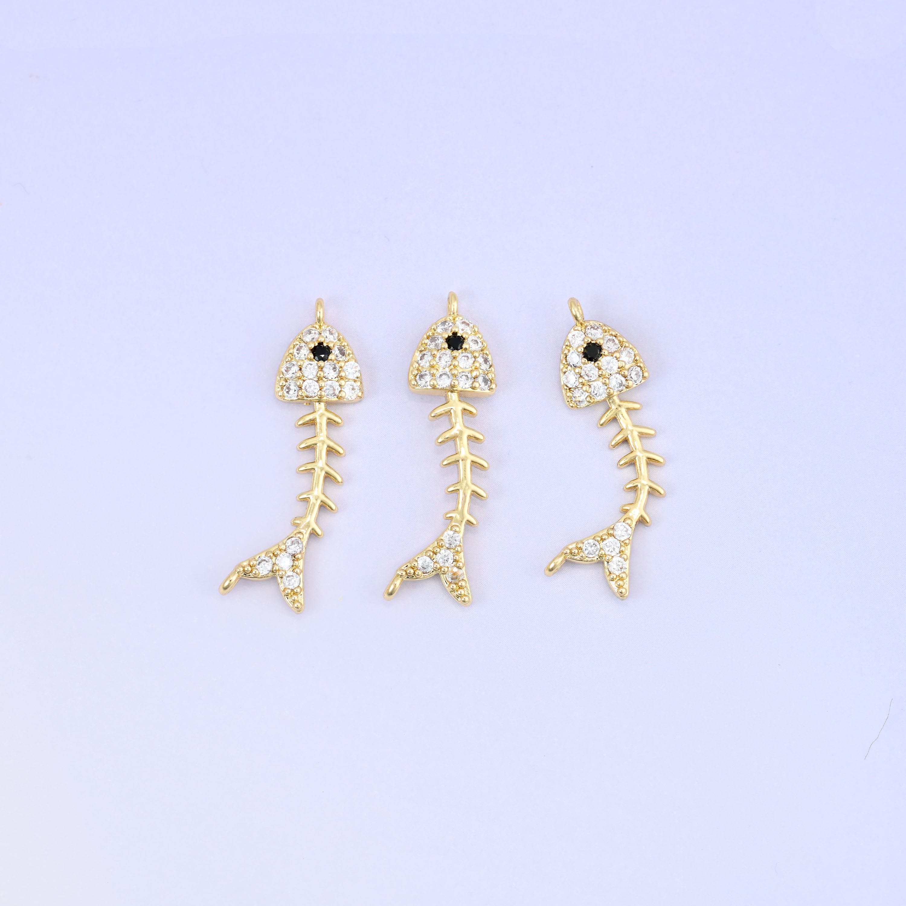 Brass fishbone charm with sleek zirconia accent