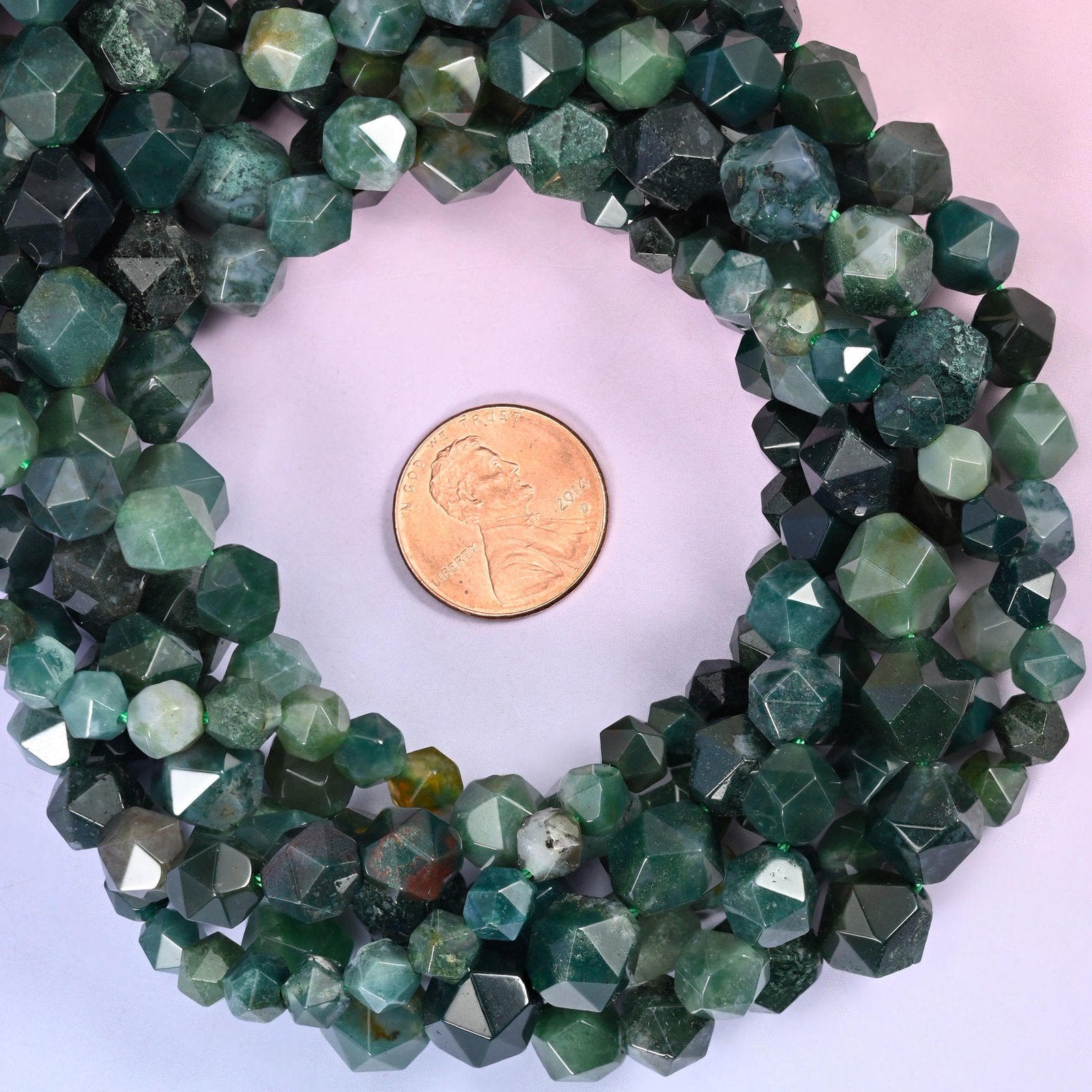 Moss Agate beads coiled around a US penny, hole size approximately 1.0mm, deep green with lighter grey-green zones