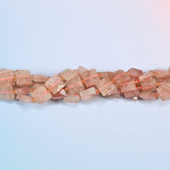 Strands of natural strawberry quartz faceted flat square beads twisted together in a horizontal row