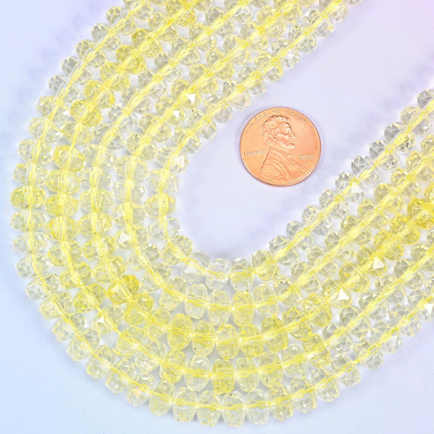 Faceted rondelle cut transparent yellow glass beads