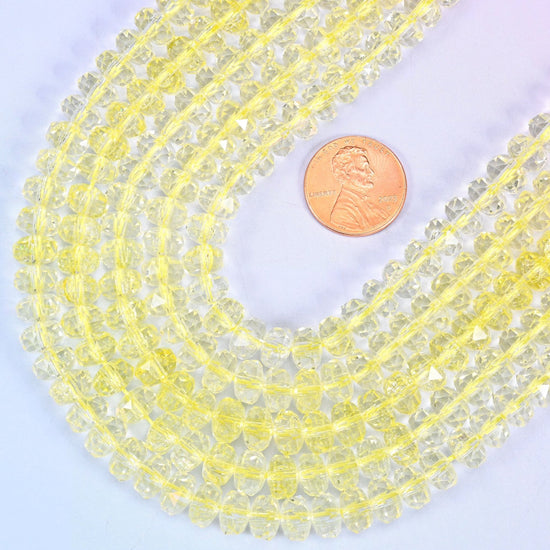 Faceted rondelle cut transparent yellow glass beads