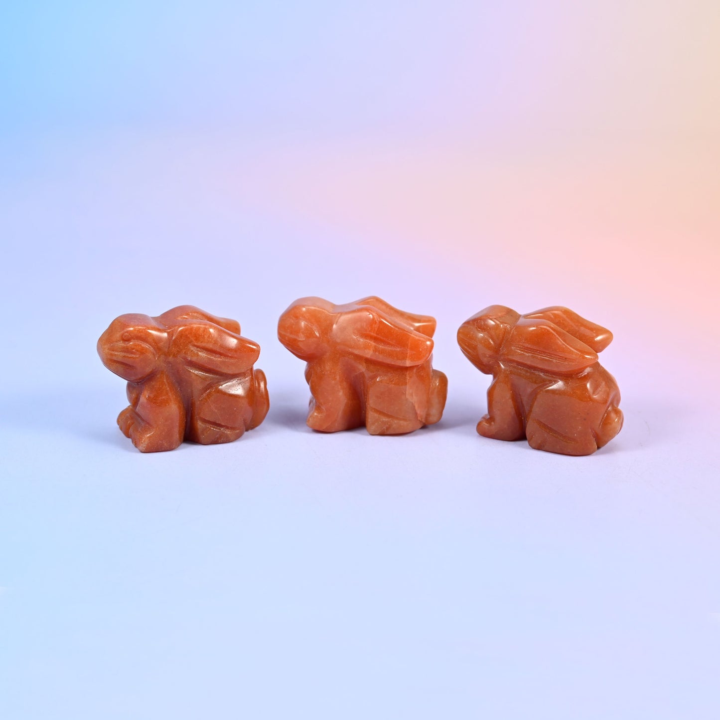 1.5 inch laying down bunny crystal figurine, carved with folded ears, tucked paws and a rounded tail