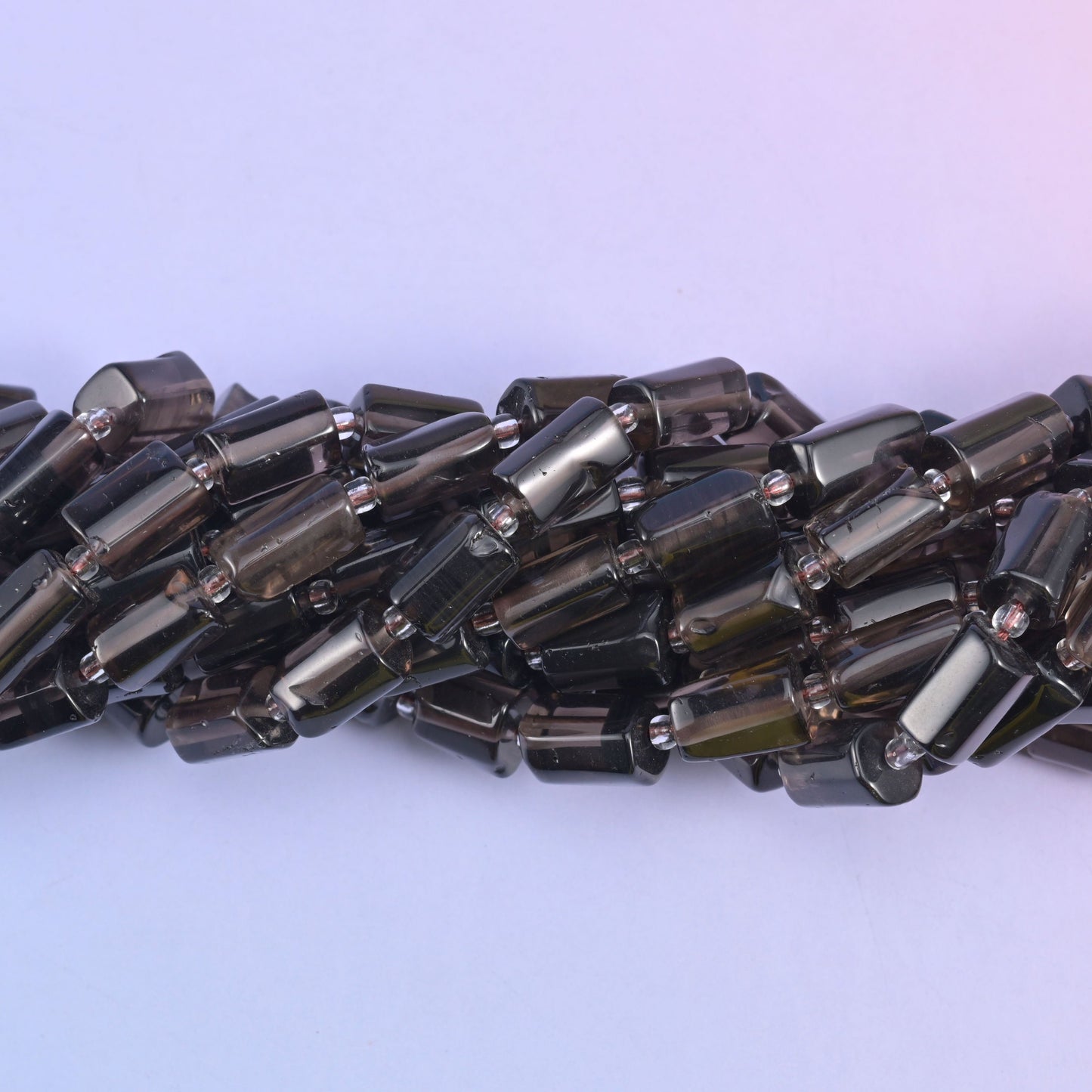 Faceted tube cut smoky quartz beads.