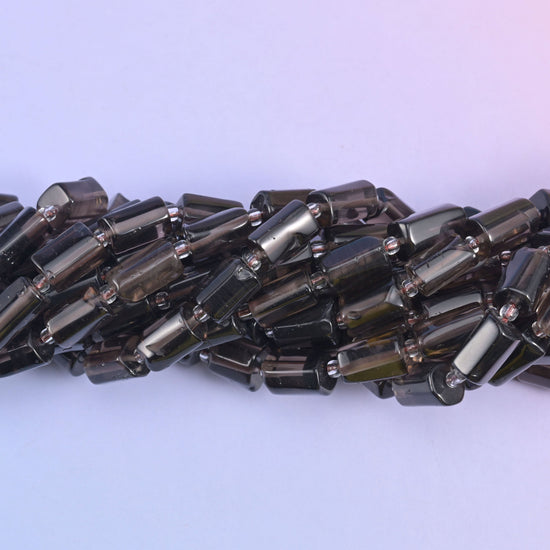 Faceted tube cut smoky quartz beads.