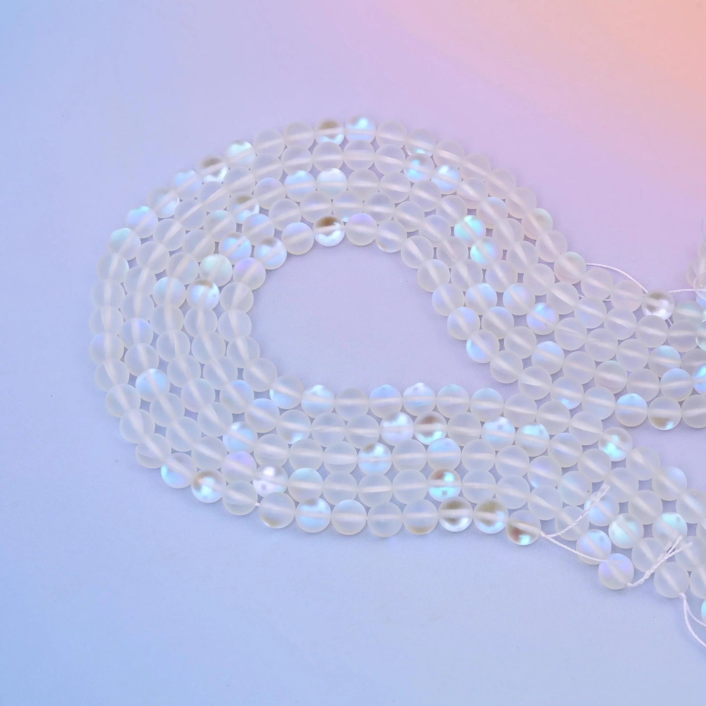 Mystic Aura Mermaid Clear Glass Beads 6mm 8mm in frosted clear with pink and blue iridescence