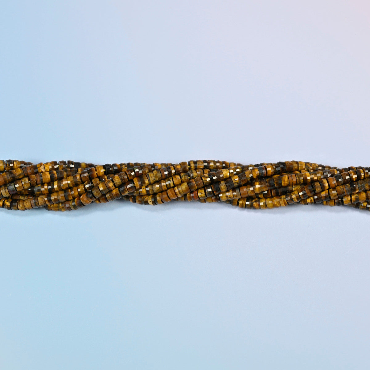 Strands of tiger eye faceted heishi disc beads twisted together in a horizontal row