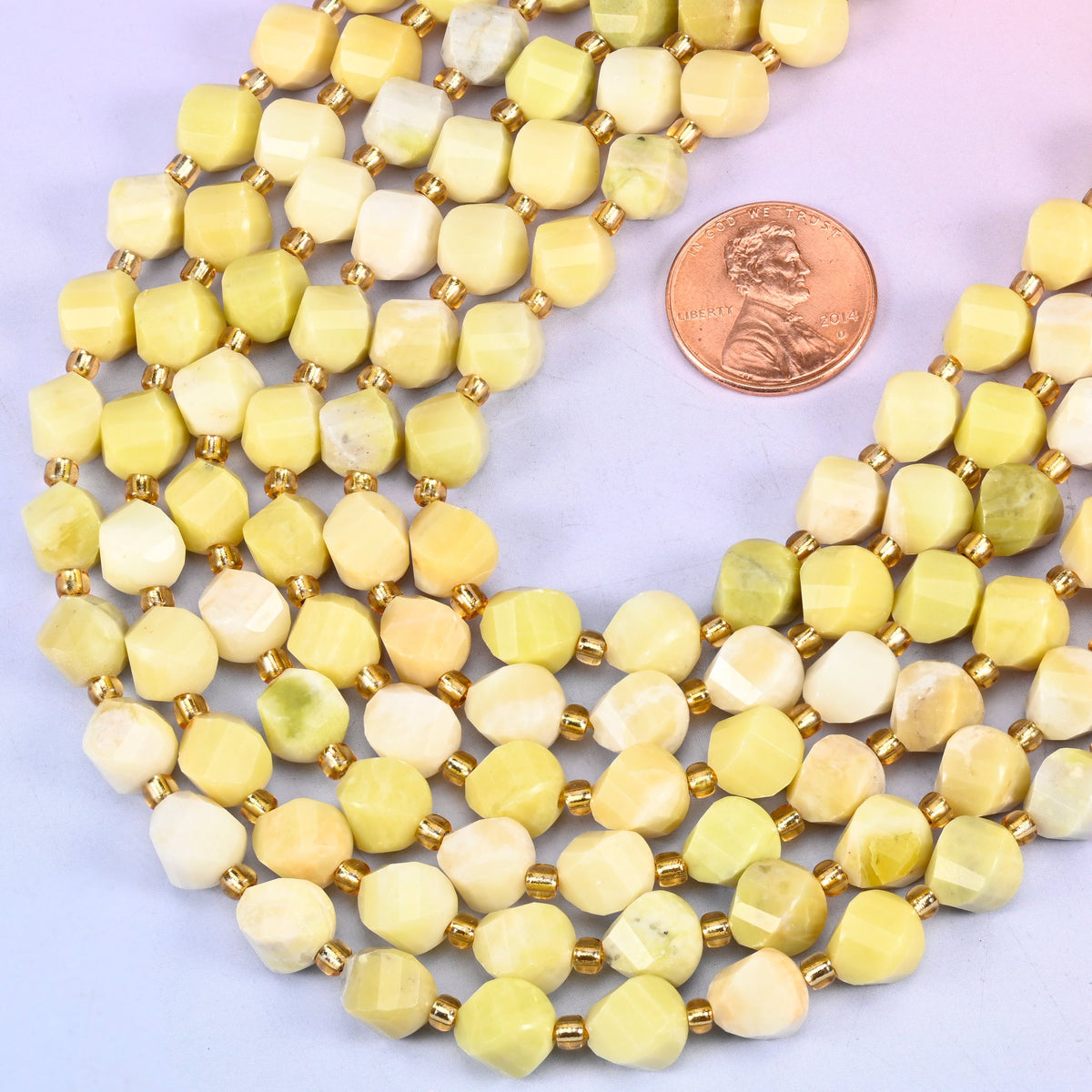 Lemon Jade yellow jade beads, many-sided spiral twist cut catching light on every facet, 8mm