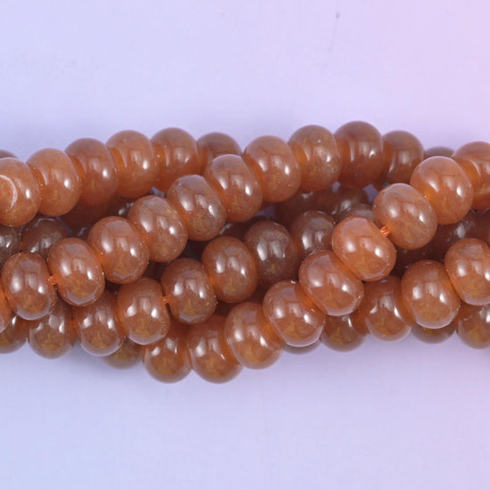 Smooth rondelle cut dyed jade beads with a polished surface