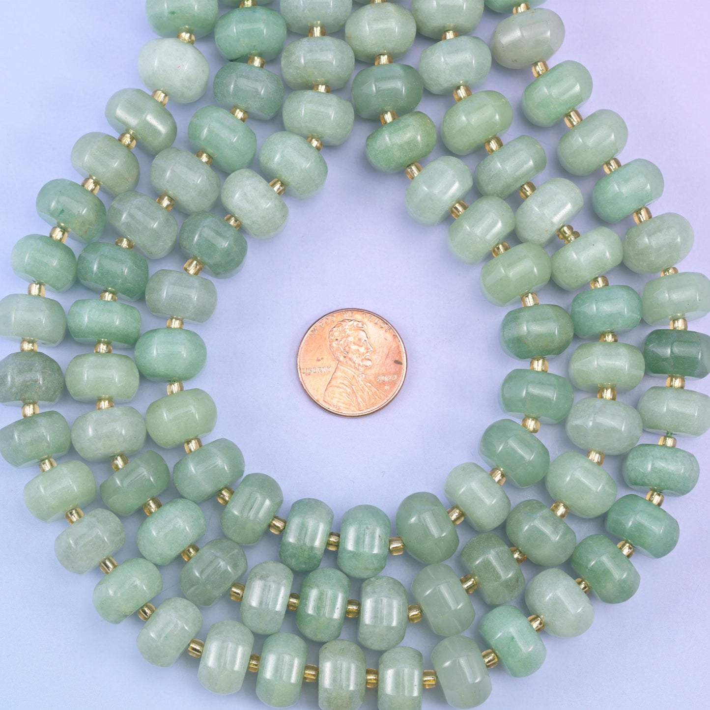 Green aventurine smooth pumpkin beads in soft mint-to-forest green tones with a gentle sparkle