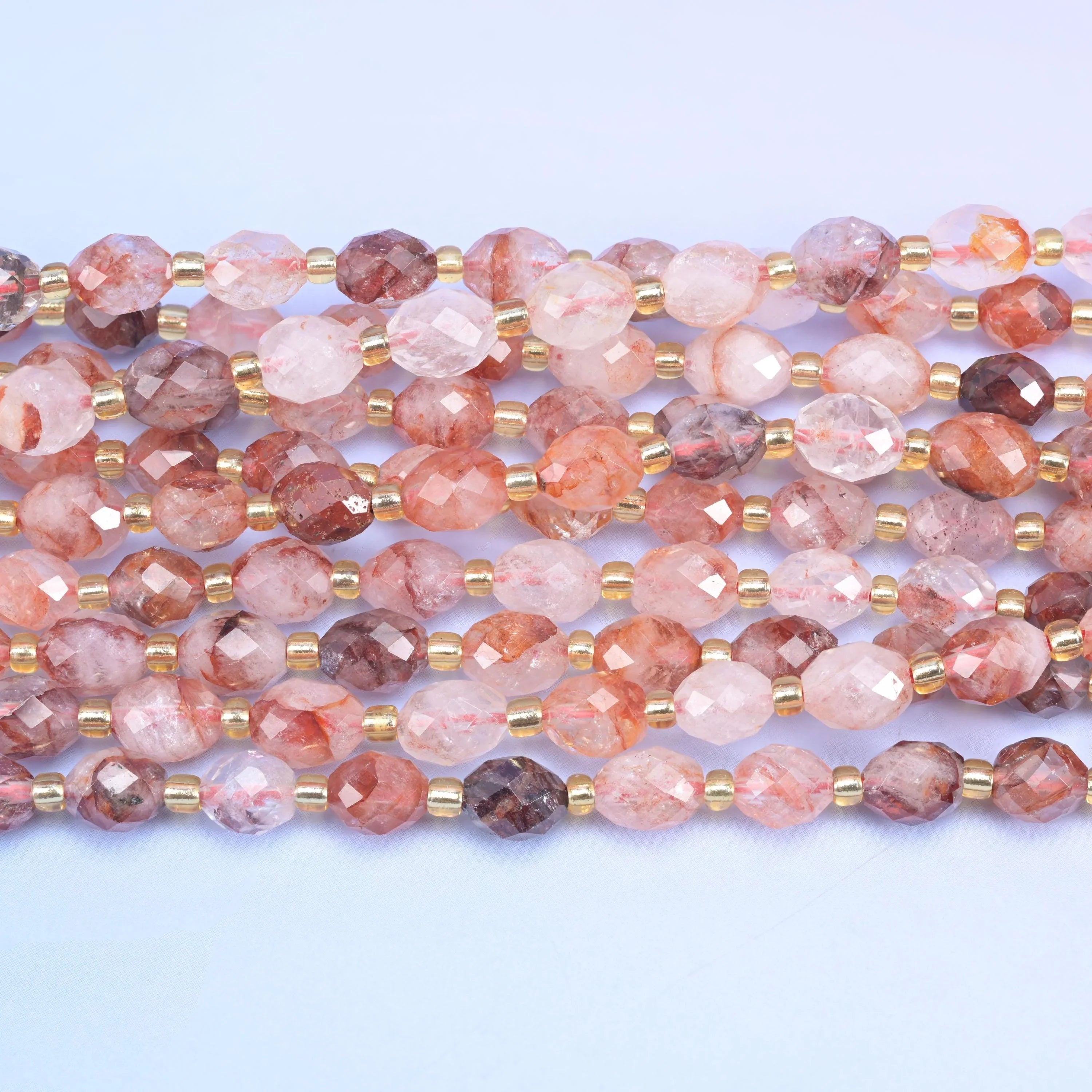 Faceted rice barrel cut red hematoid beads