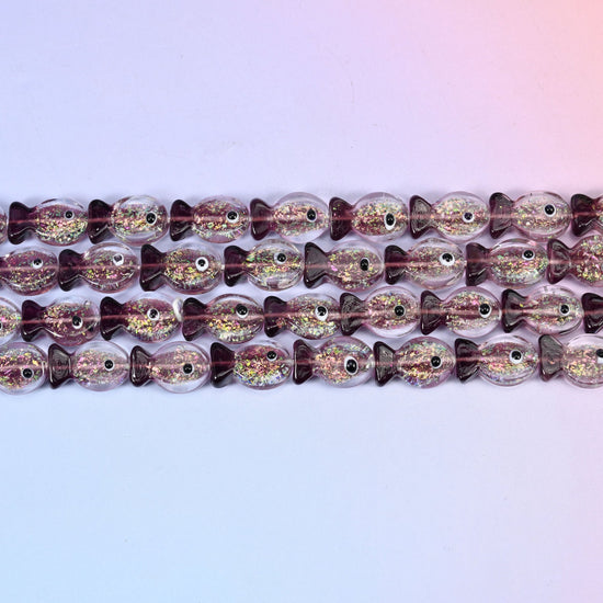 Iridescent purple fish glass beads in amethyst-tinted glass with green and gold glitter foil
