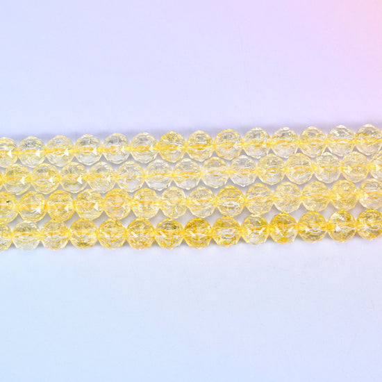 Transparent yellow faceted round glass beads in clear lemon-to-champagne