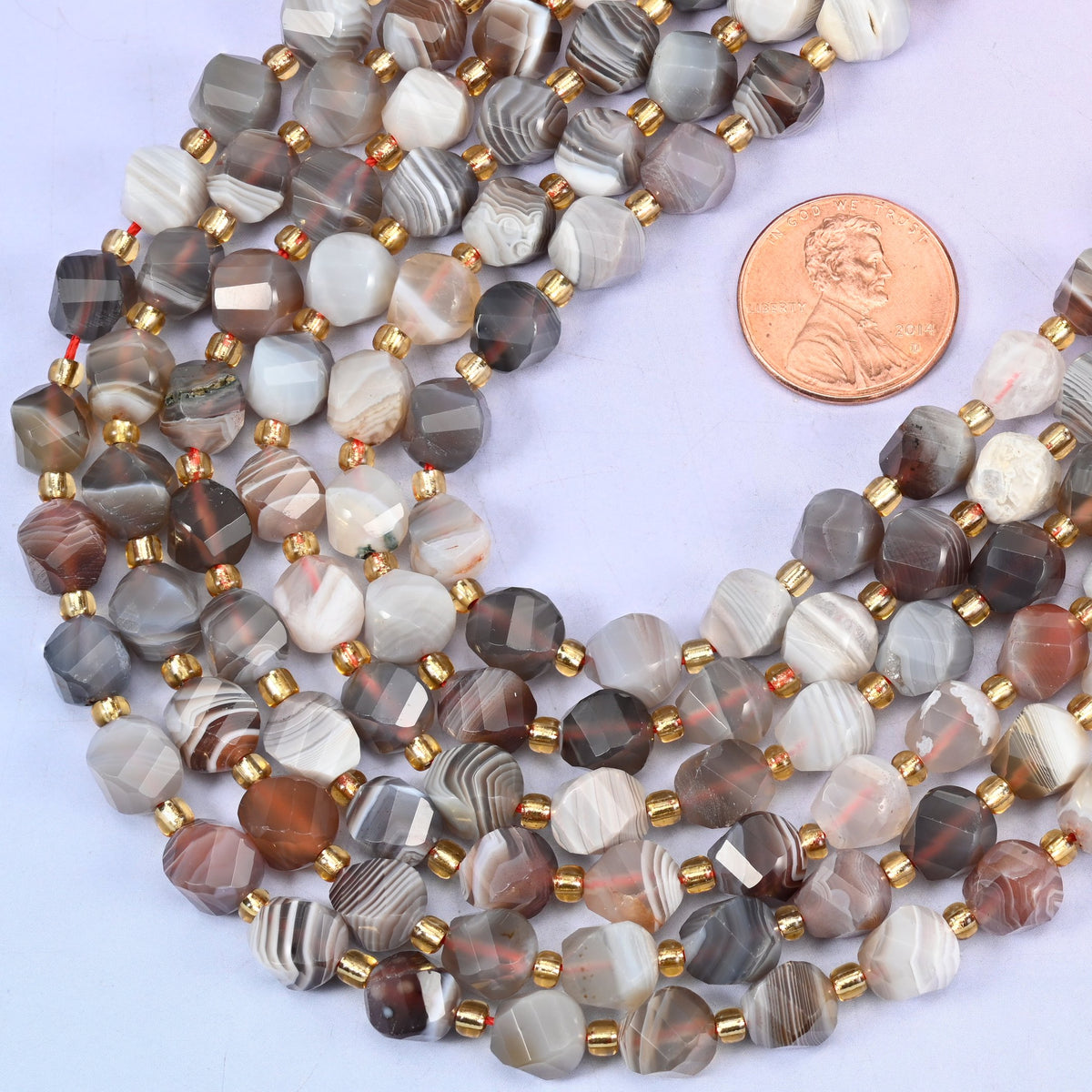 Botswana agate natural stone beads with small gold spacer beads set between each 8mm faceted bead