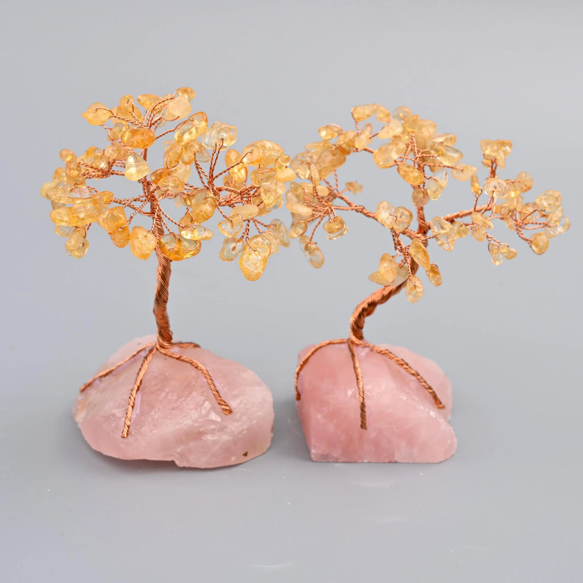 Copper wire tree of life sculpture on a raw rose quartz base