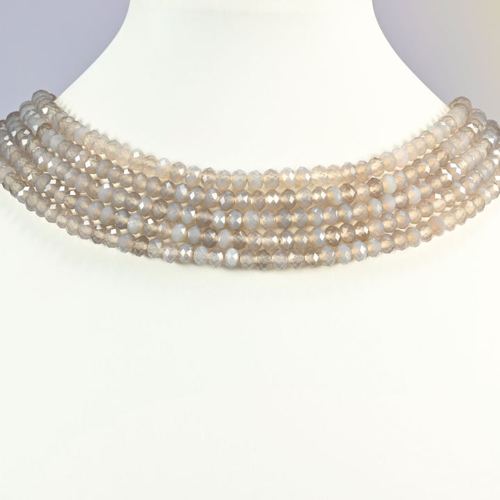 Gray Agate faceted rondelle beads shown on a white neck display, several 15 inch strands sitting together like a collar at 4x6mm.
