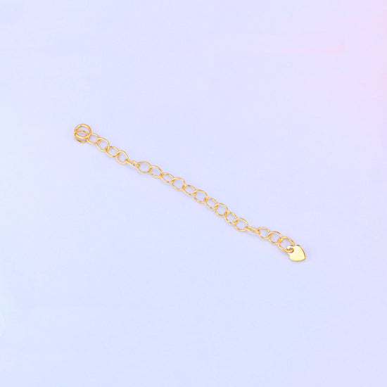 14K gold filled heart chain extender laid diagonally, cable-link chain with a jump ring loop at one end and a small heart charm at the other.