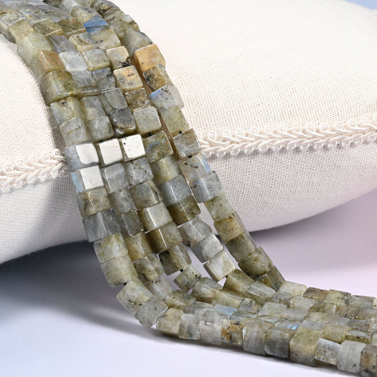 Gray Labradorite cube beads draped in a soft curve, four-sided cubes in gray with a green cast