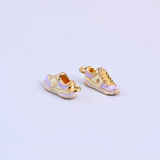 Two light purple sneaker charms facing opposite ways, showing both sides of the shoe.