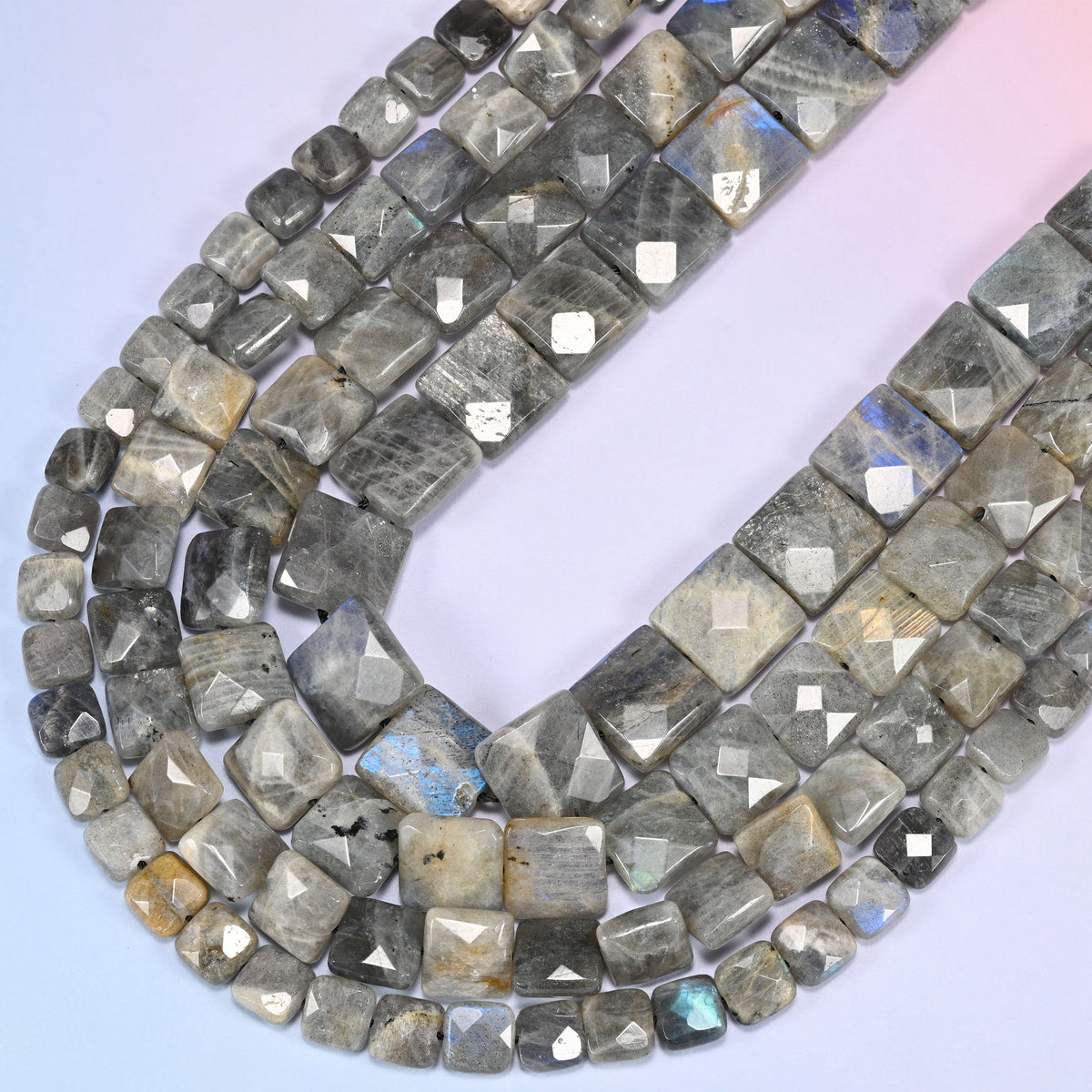 Gray Labradorite faceted flat square beads curving in a wide loop, blue flash traveling across the broad faces