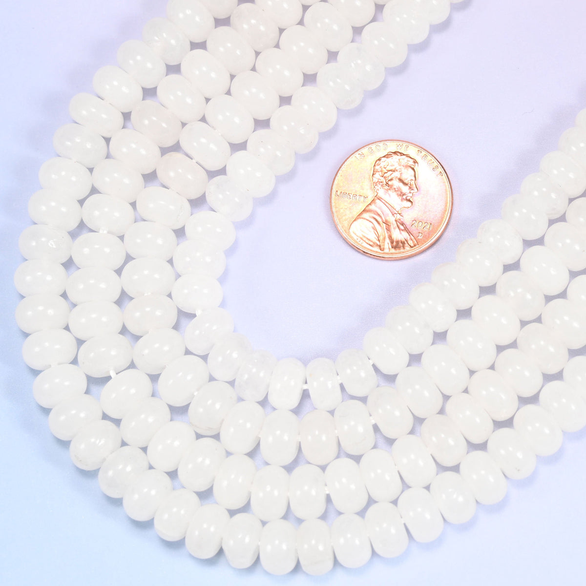 Rondelle cut Natural White Jade beads with a soft translucent glow.