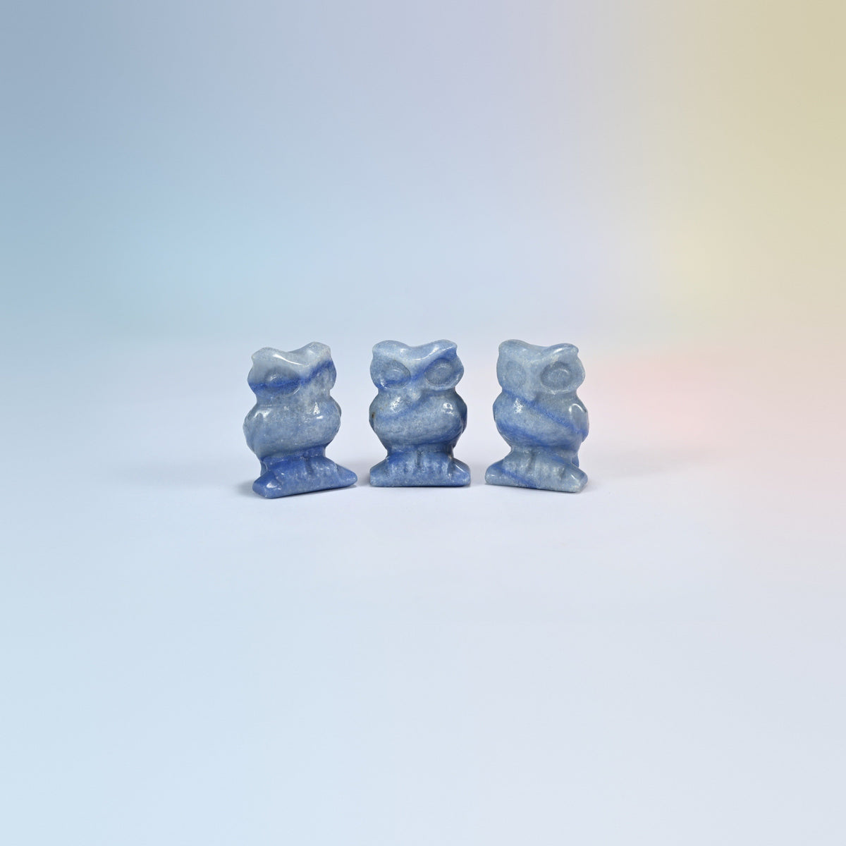 Owl crystal carving in blue aventurine, blue natural stone with a soft shimmer