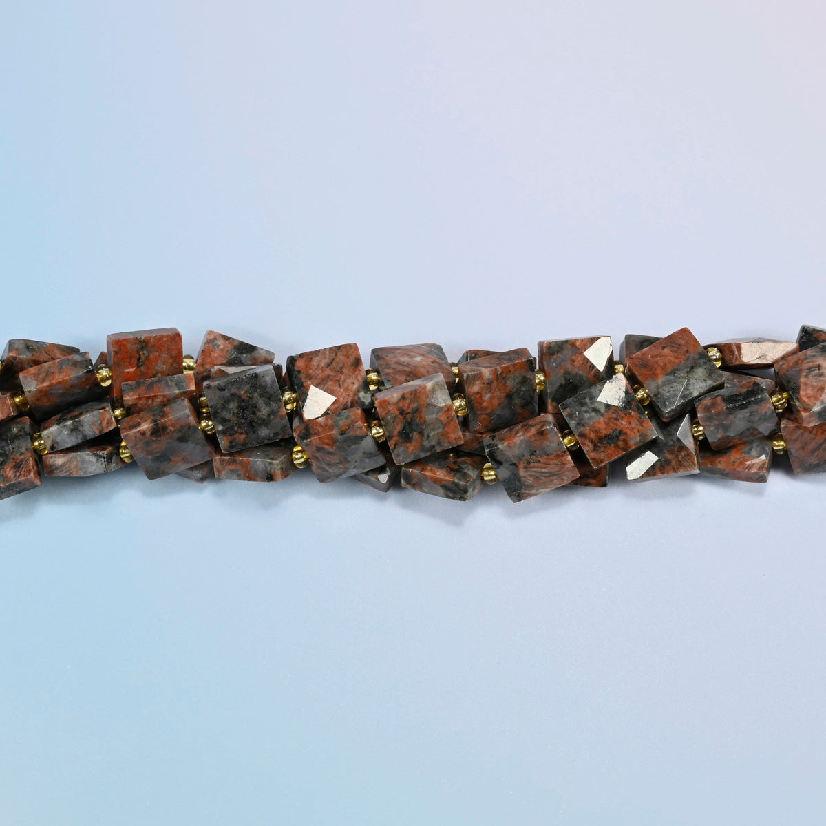 Strands of natural red sesame jasper faceted flat square beads twisted together in a horizontal row