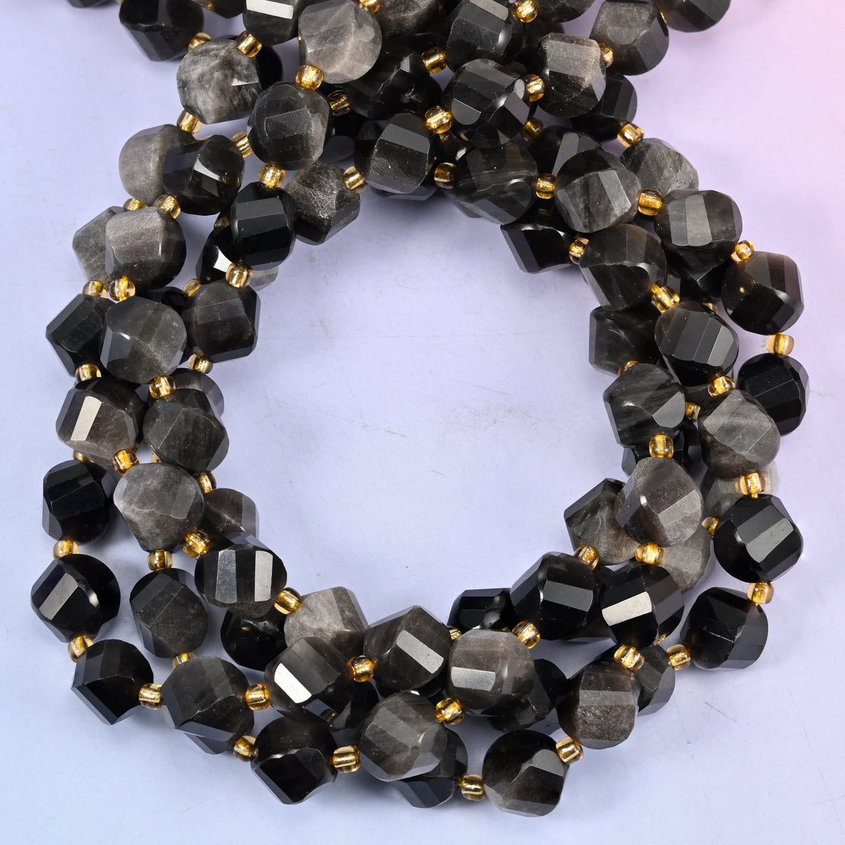 Natural silver obsidian stone beads in a 10mm faceted spiral twist cut
