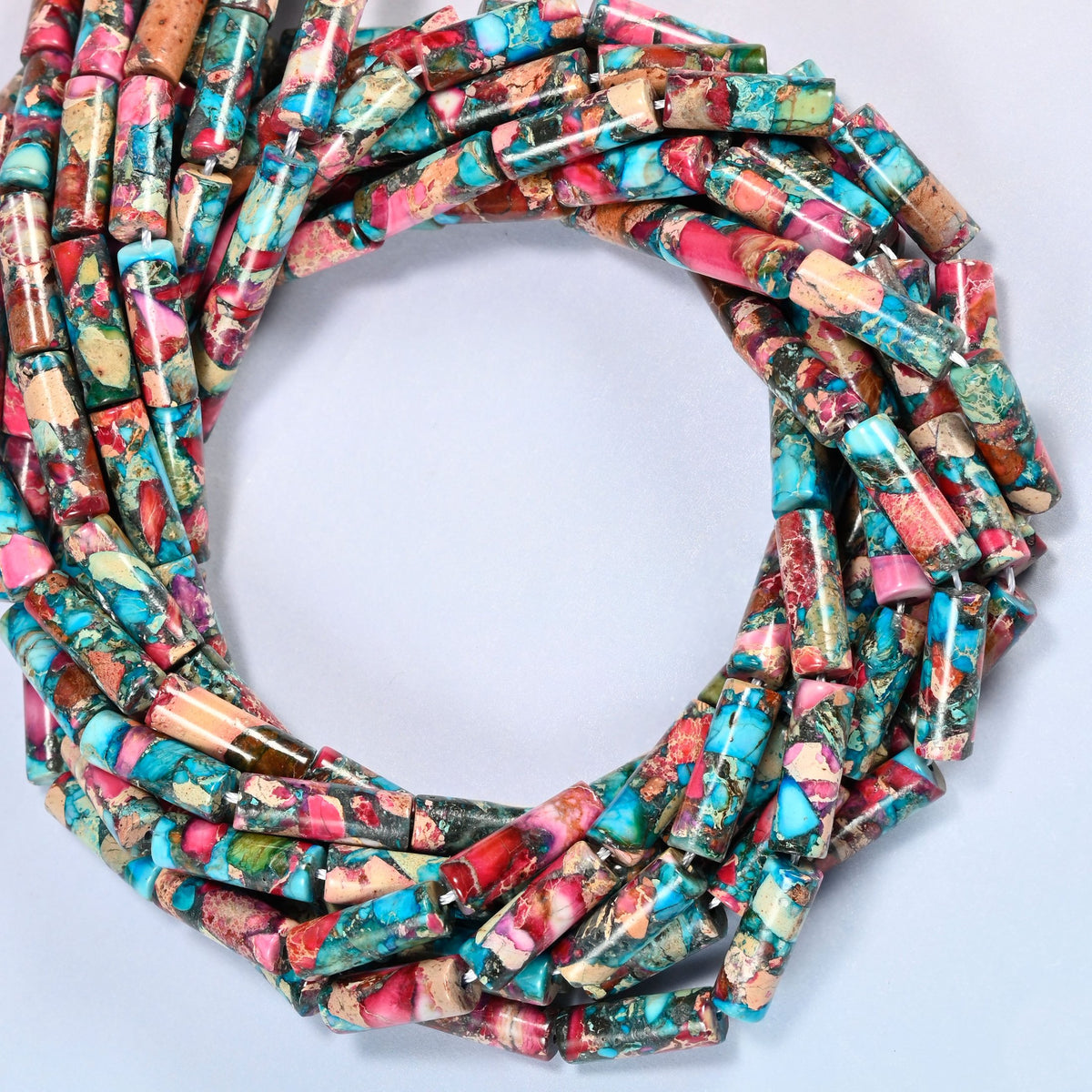 Dyed sea sediment jasper tube beads 13x4mm coiled into overlapping loops, whole strands of turquoise, pink and brown tubes