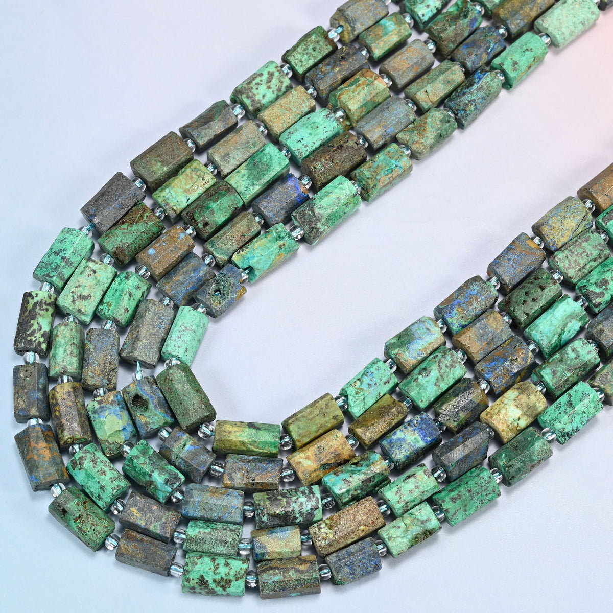 Azurite chrysocolla faceted tube beads in several strands curved into a wide U, green stone with blue azurite spots
