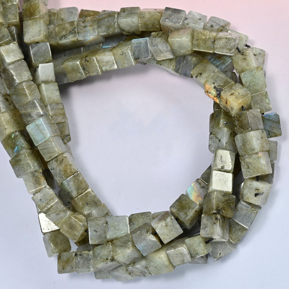 Gray Labradorite cube beads coiled into a ring, an occasional silver-white face among the gray