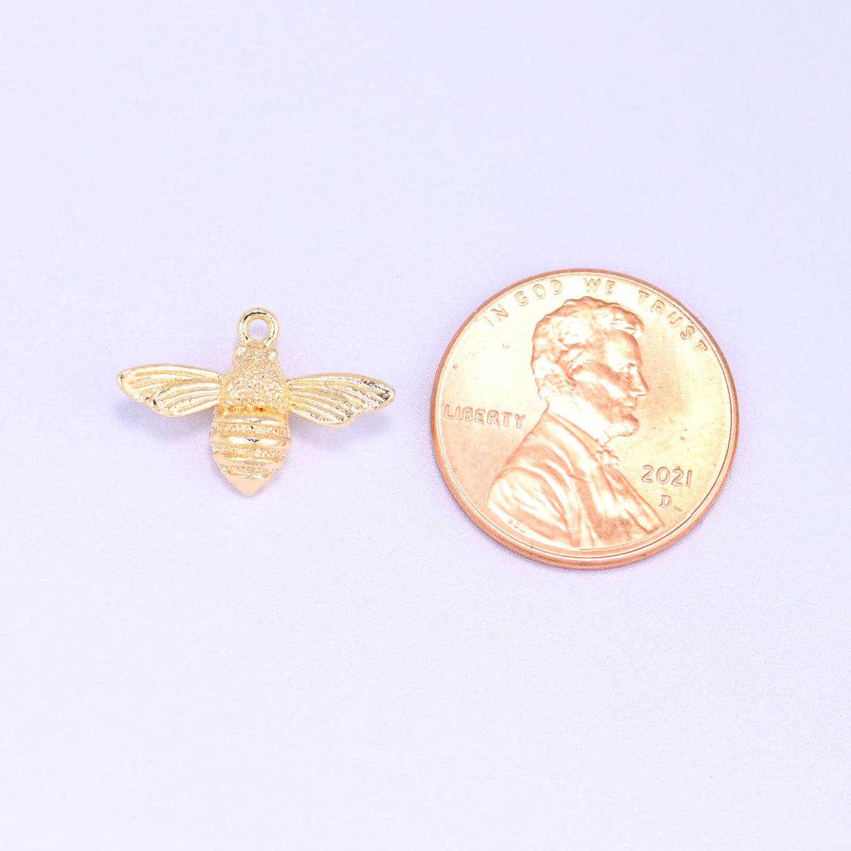 Small gold charms bee shown beside a US penny for scale, 18K gold plated 17x11.7mm charm