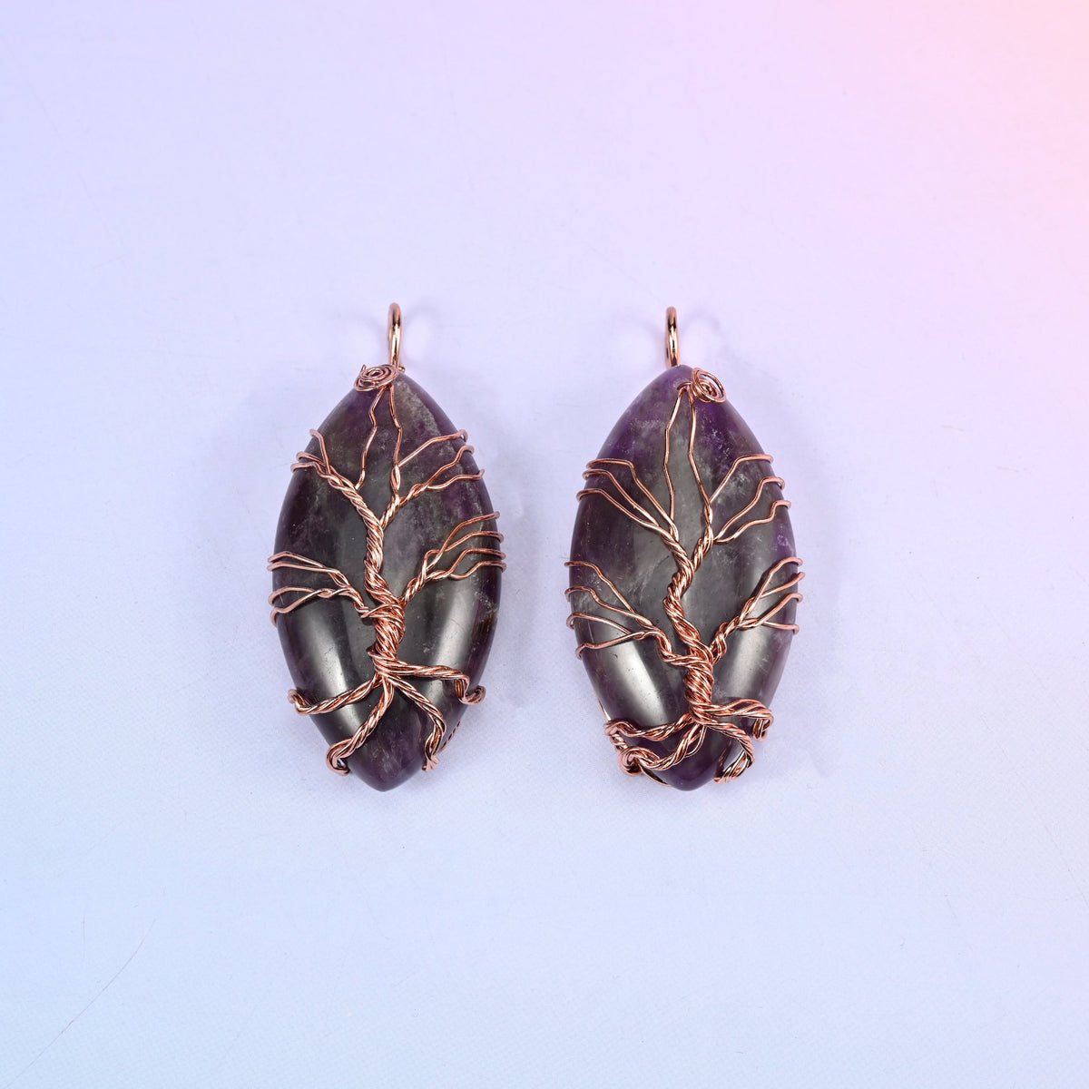 Oval Crystal Pendant with Copper Wired Tree in deep purple amethyst, two pieces where the dark stone throws the copper branches into relief.