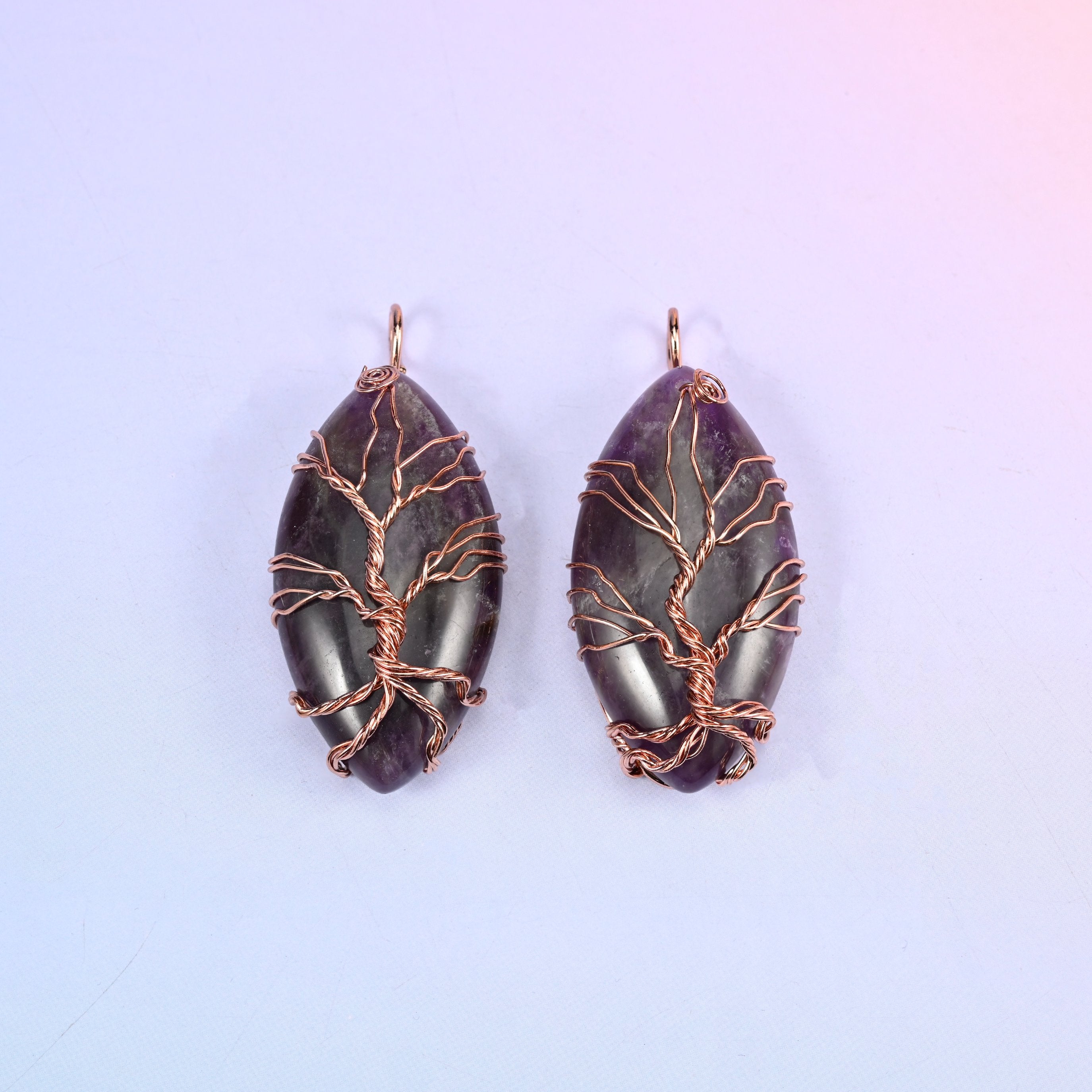 Oval Crystal Pendant with Copper Wired Tree in deep purple amethyst, two pieces where the dark stone throws the copper branches into relief.