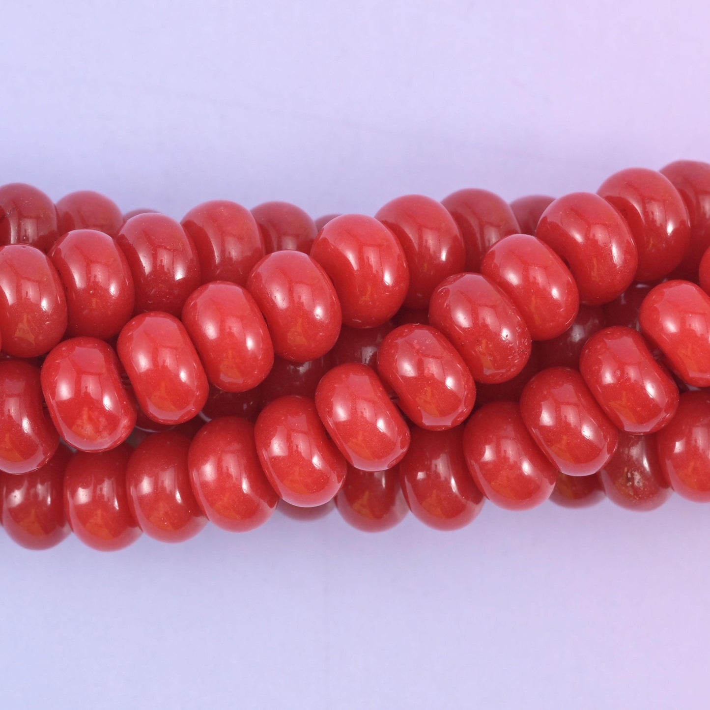 Smooth rondelle cut dyed jade beads with a polished surface