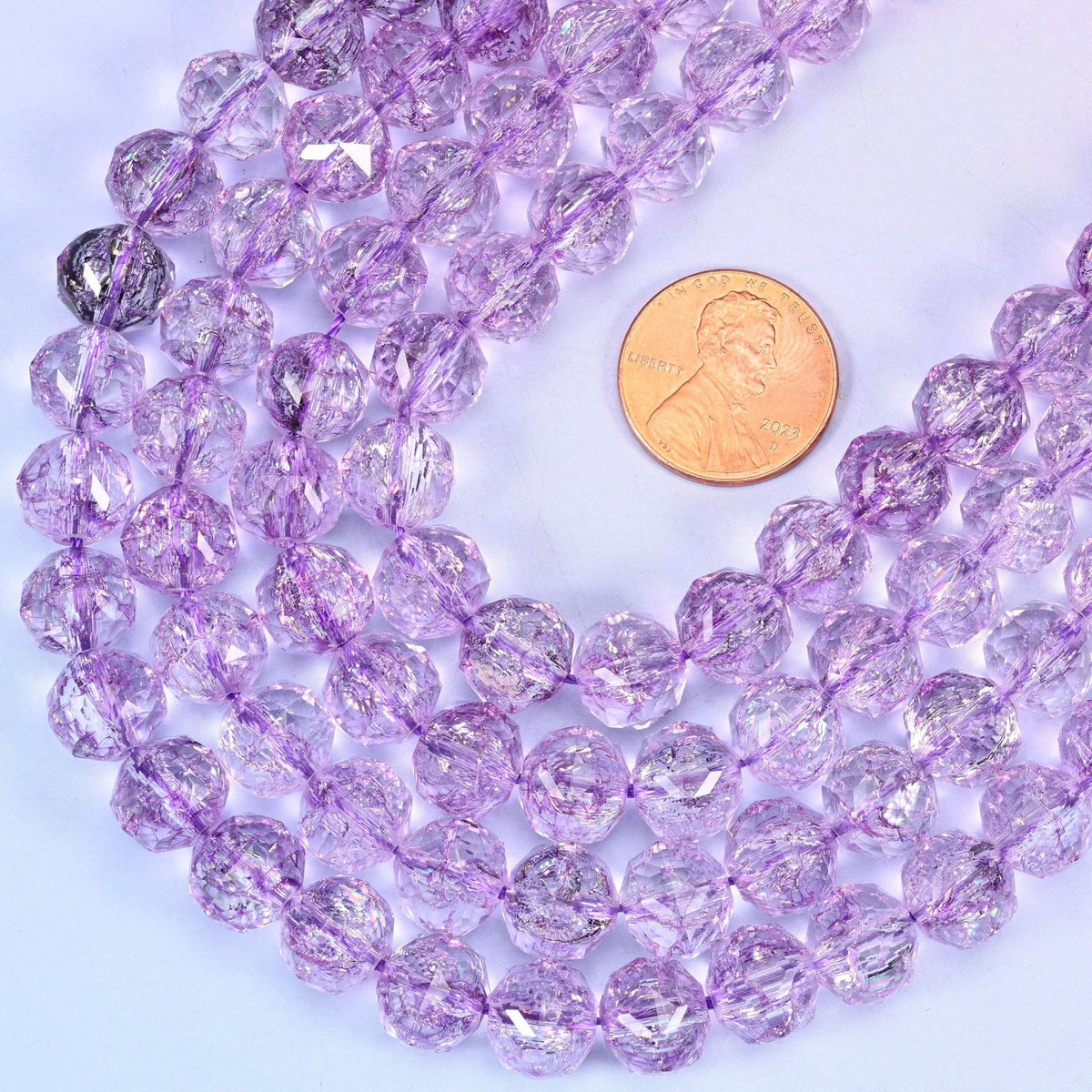 Faceted round cut transparent purple glass beads