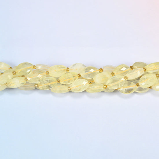 Strands of citrine faceted flat oval beads twisted together in a horizontal row