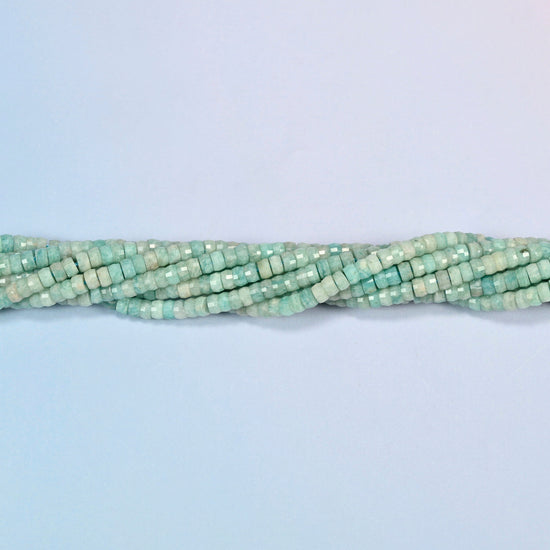 Strands of green amazonite faceted heishi disc beads twisted together in a horizontal row