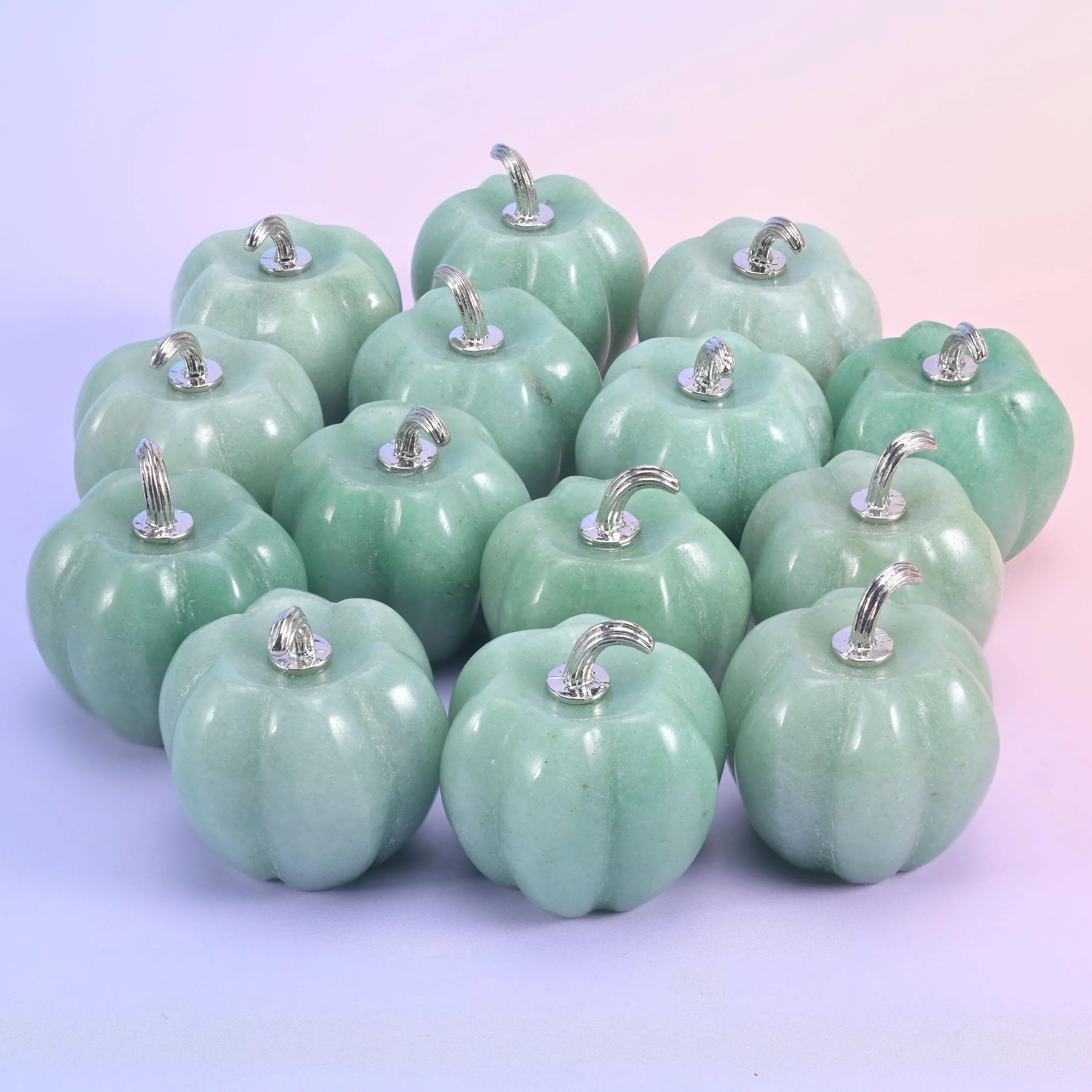 1.2 inch gemstone pumpkin carving with ribbed sides and a curling silver-tone metal stem