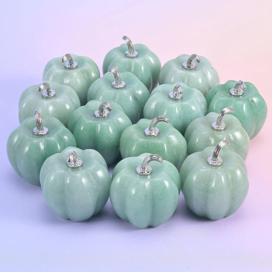 1.2 inch gemstone pumpkin carving with ribbed sides and a curling silver-tone metal stem