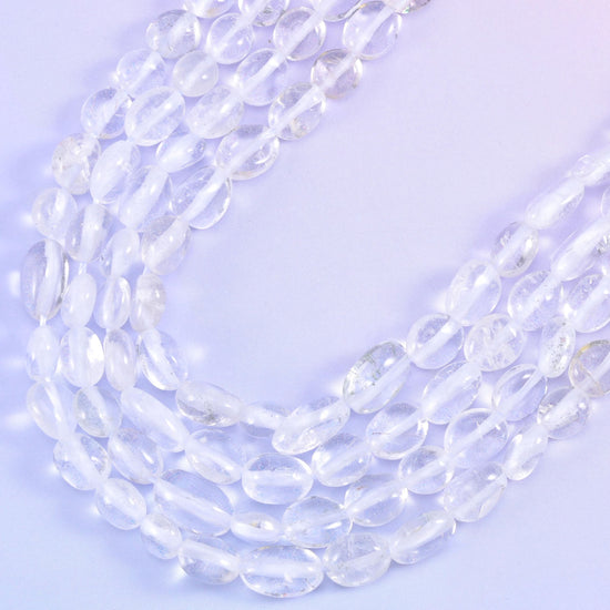 Strands curving into a soft V, colourless beads picking up the lilac background