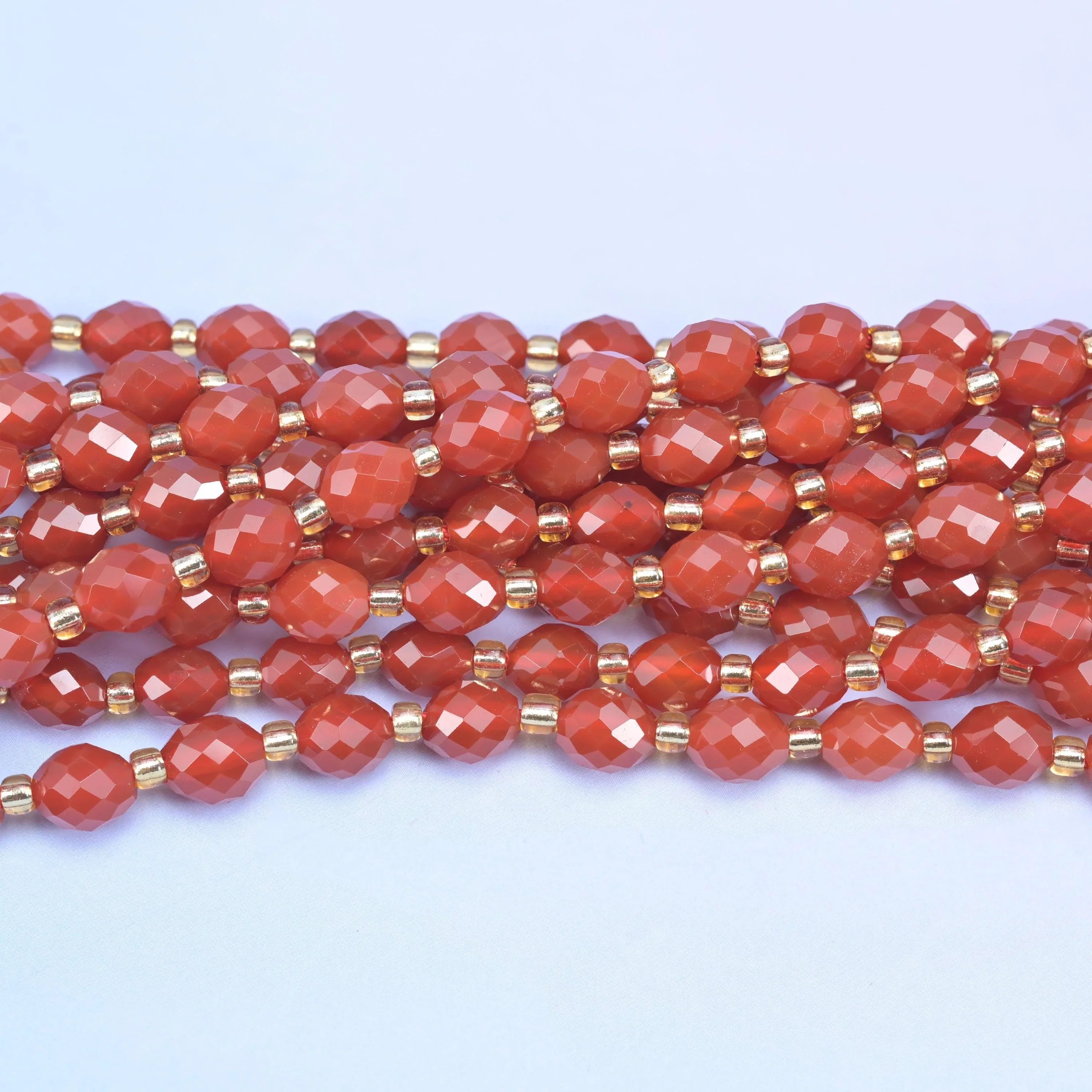 Faceted rice barrel cut red agate beads