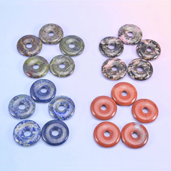 Green and grey speckled donuts beside deep blue lapis and terracotta red aventurine