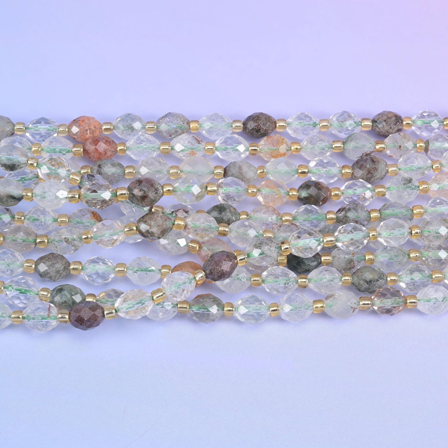 Faceted rice barrel cut green phantom quartz beads