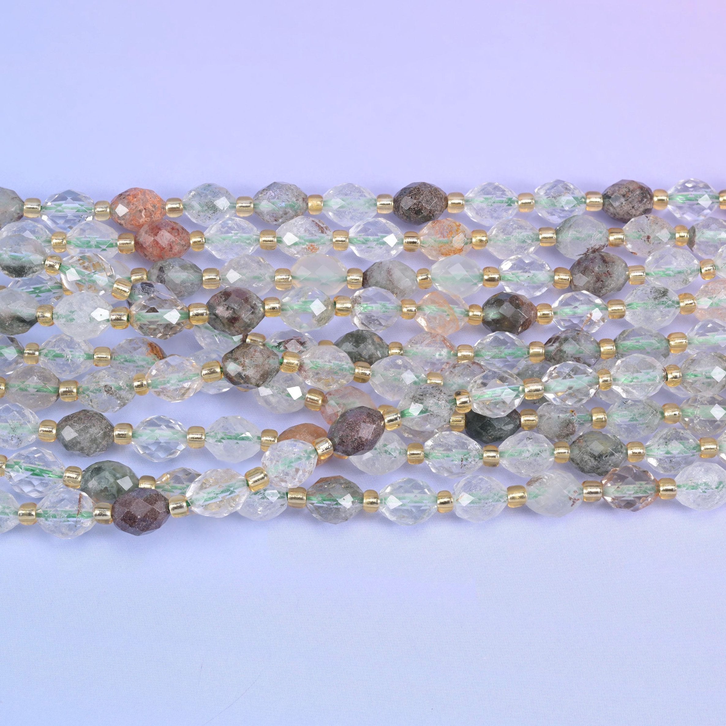 Faceted rice barrel cut green phantom quartz beads