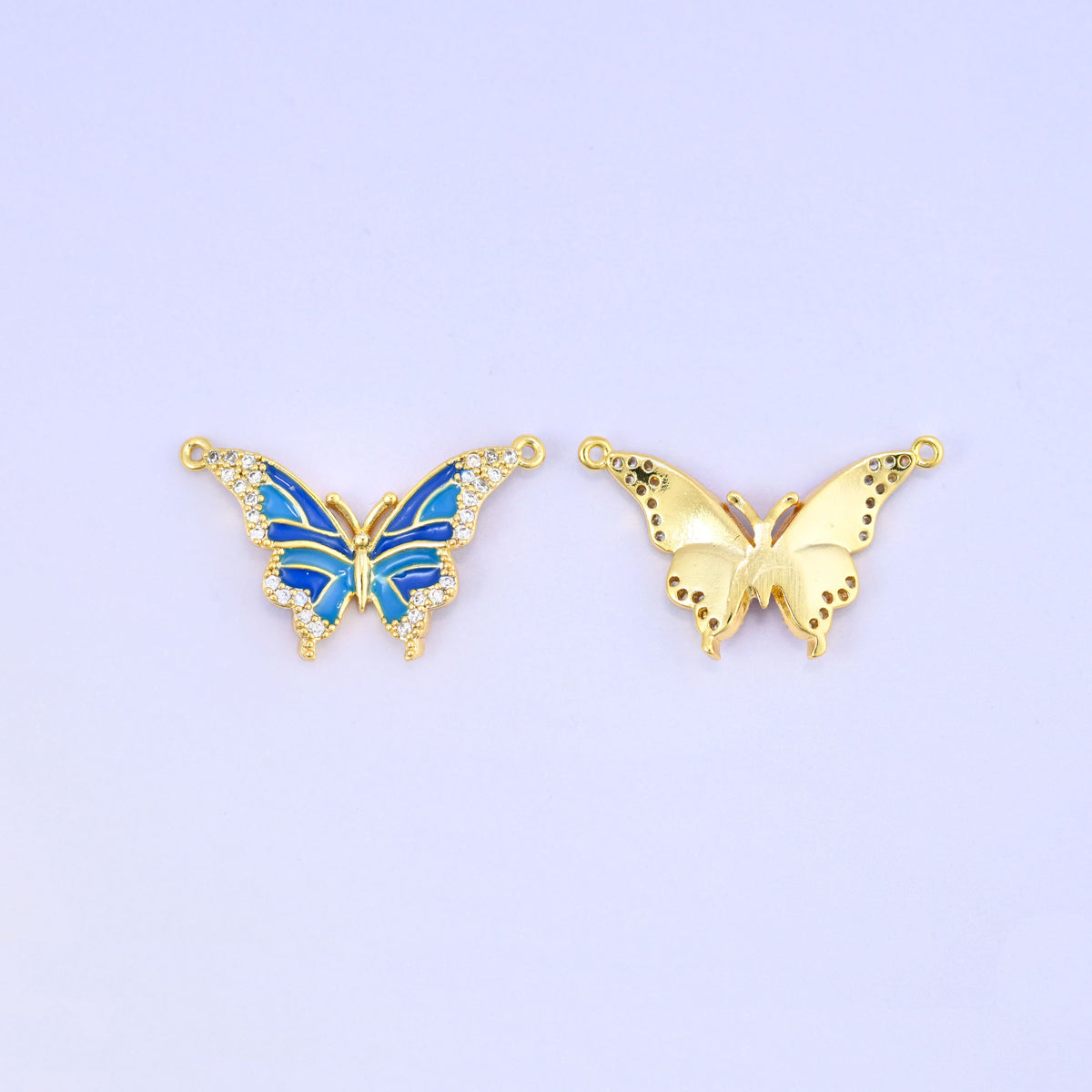 Front and back of the blue enamel butterfly connector, the enamelled zircon edged face beside the plain brushed gold reverse with its two connector loops.