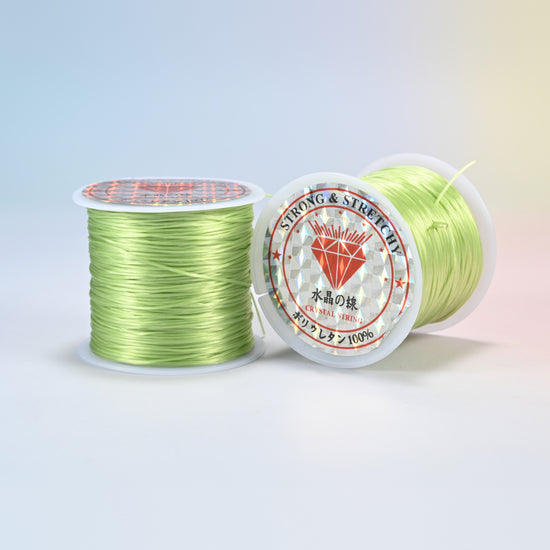 Two rolls of light green 0.7-0.8mm elastic stretch string, glossy polyurethane bead cord with a holographic label
